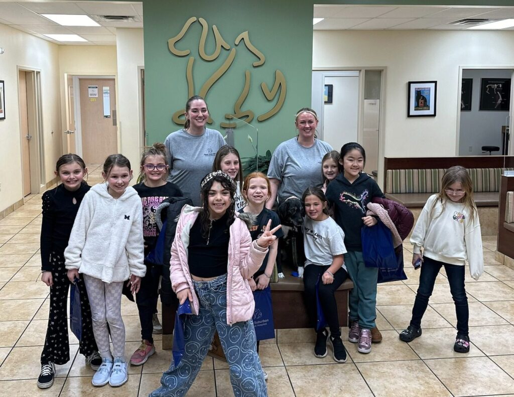 Team members from West Suburban Animal Hospital with a girl scout troop