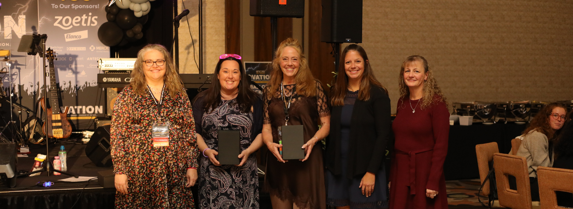 Image of leaders from Fitchburg Veterinary Hospital and Animal Emergency and Critical Care of Lynchburg accepting their award at Ovation